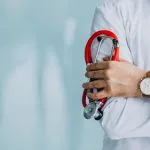 Doctor in a white coat holding a stethoscope