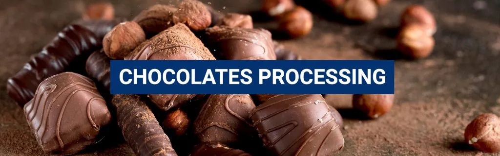 Banner reading 'Chocolates Processing' over filled chocolates and hazelnuts