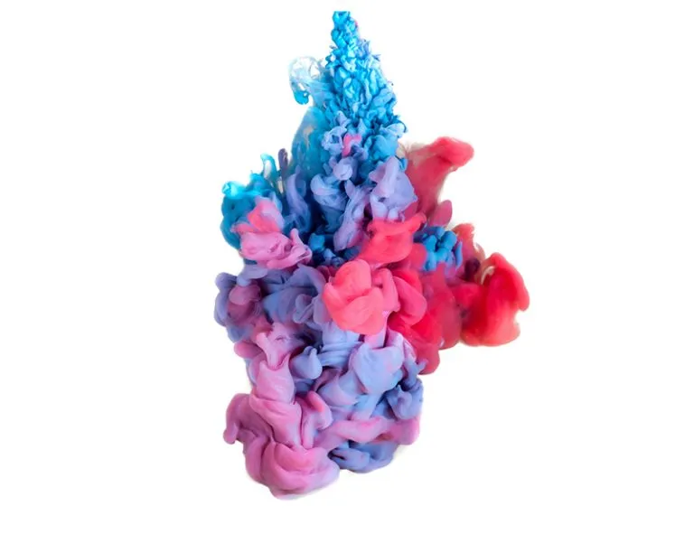 Blue, pink and red ink clouds dispersing in liquid