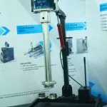 Wahal enclosed shaft homogenizer on a hydraulic lift stand at an exhibition booth