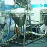 Wahal conical hopper mixers with inline pumps and hoses on display at a trade show
