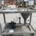 Wahal powder induction mixer with conical hopper and motor on a wheeled stainless steel frame