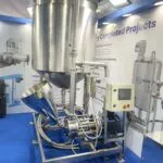 Wahal liquid powder mixer with angled feed hopper, vessel and control panel at an exhibition stand