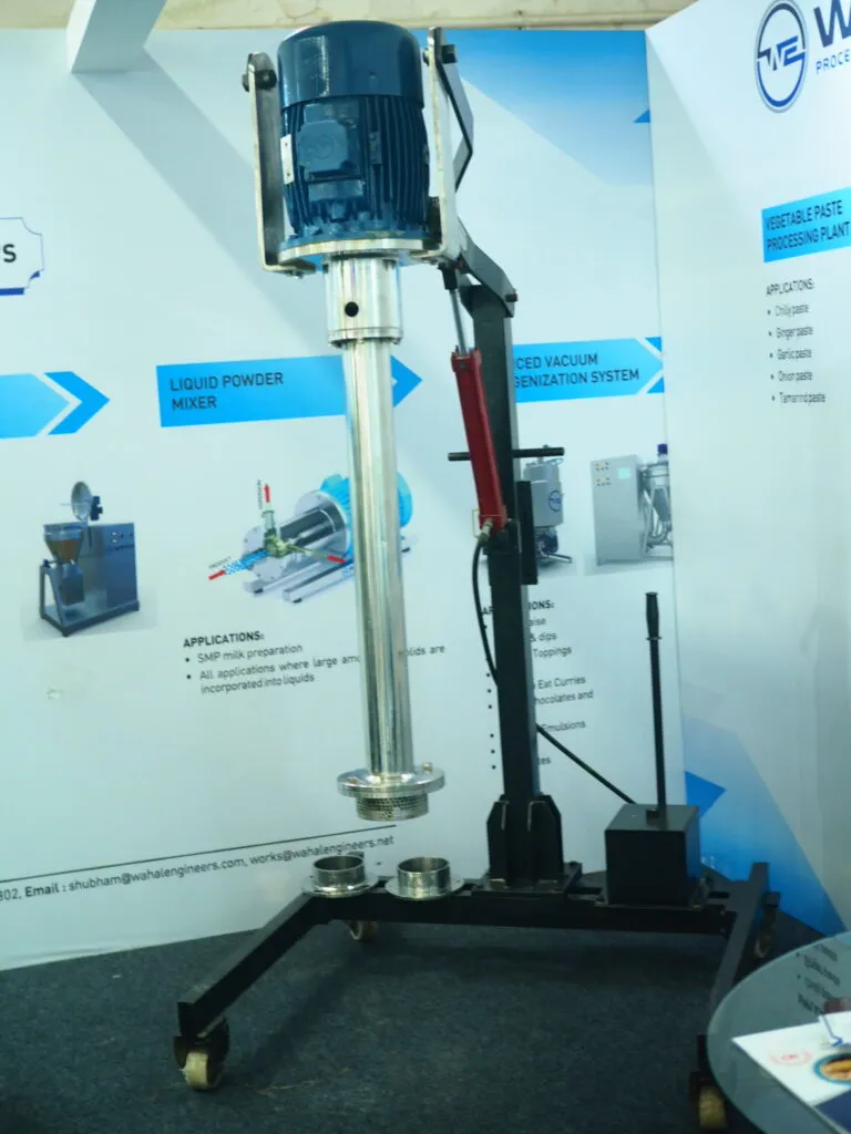 Wahal enclosed-shaft IBC tank mixer on a hydraulic lifting stand at an exhibition booth
