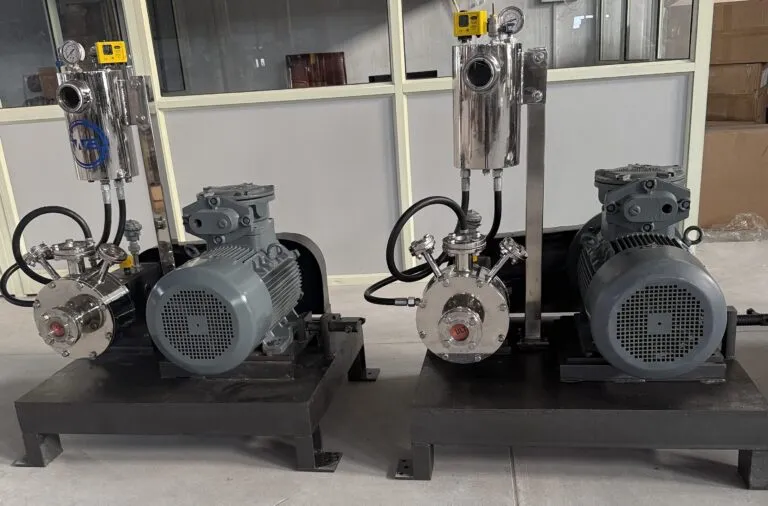 Two Wahal inline high shear mills with seal support vessels and motors on steel base frames