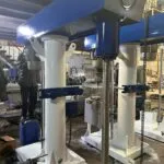 High speed disperser with twin white lift columns being assembled in a workshop