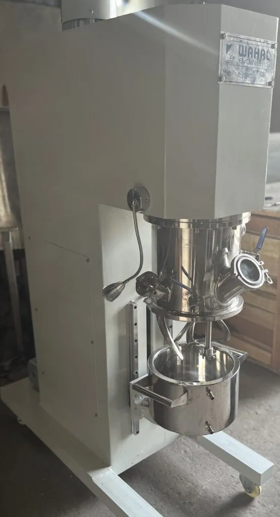 Wahal double planetary mixer with the mixing head raised above its stainless steel bowl on a wheeled frame